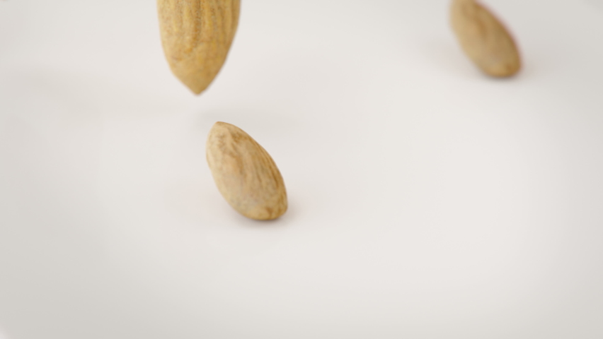 Almonds Nuts Falling Into Milk in 4K Super slow motion Royalty-Free Stock Footage #1058560741