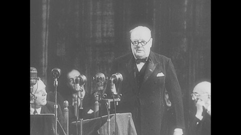 1950s: People listen to speech in assembly. Winston Churchill gives speech to assembly. People in assembly listening. Winston Churchill gives speech.