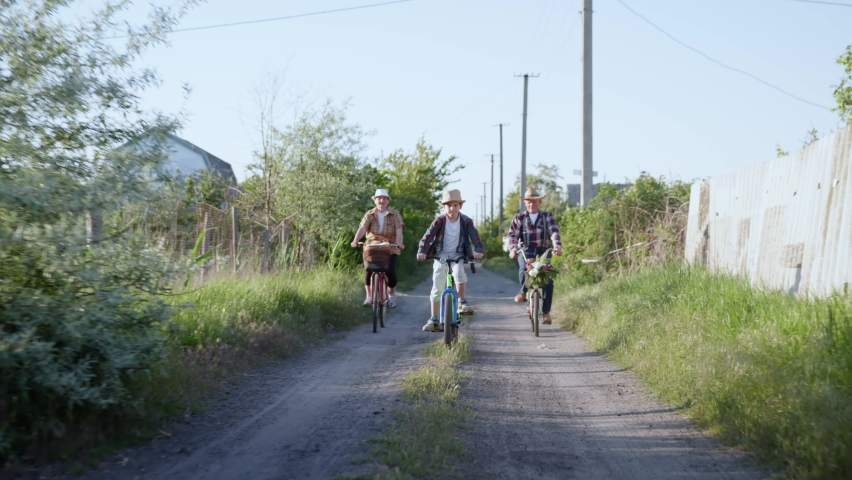 family fun, charming little boy with grandparents enjoying a weekend together with children and cycling along a rural road, lifestyle