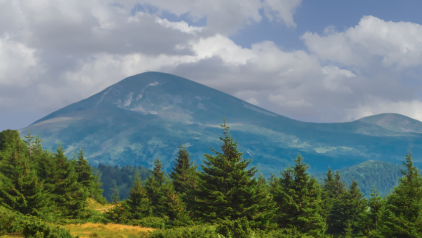 beautiful high mountain under a dense cloudy sky, outdoor time lapse scene