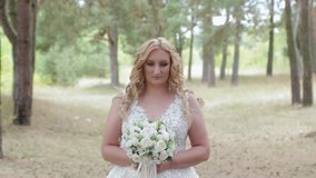 Bride with wedding bouquet in green summer forest. - Powered by Shutterstock - Get 15% off with code: PIKWIZARD15
