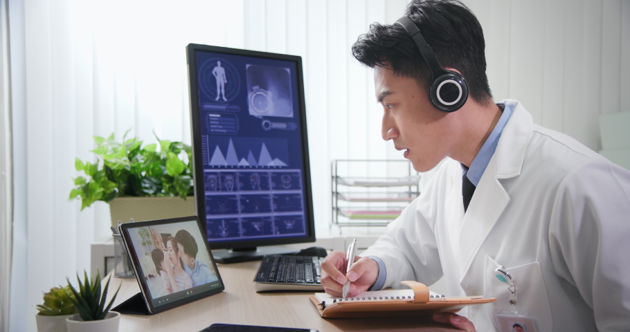 Telemedicine concept - asian male pediatrician is listening to the family and then talking about their kid symptom on digital tablet Royalty-Free Stock Footage #1058582638
