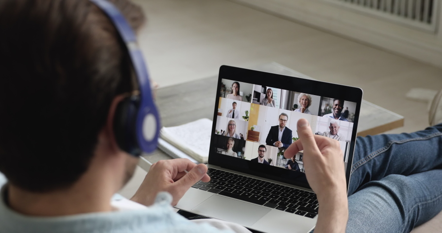 Pc screen where diverse people take part at group video conference, view over male shoulder participant of video call. Telework easy and convenient, modern tech, work from home due quarantine concept Royalty-Free Stock Footage #1058587933