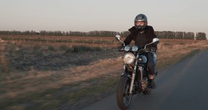 Me rides a motorcycle on a country road. Slow motion video