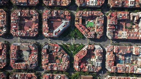 Birds eye aerial view of square buildings and trafficing through Barcelona streets in Spain