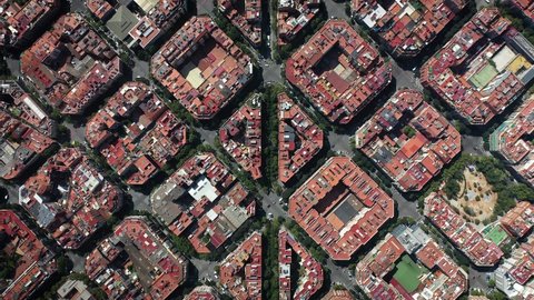 Aerial birds eye view of rectangular buildings and red roofs in Barcelona, Spain