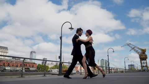 Two professional tango dancers doing a quebrada at the end of the performance