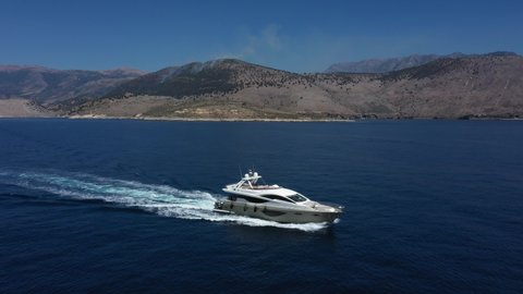 Drone filming a beautiful super luxurious motor yacht sailing in the Ionian Sea during summer season.