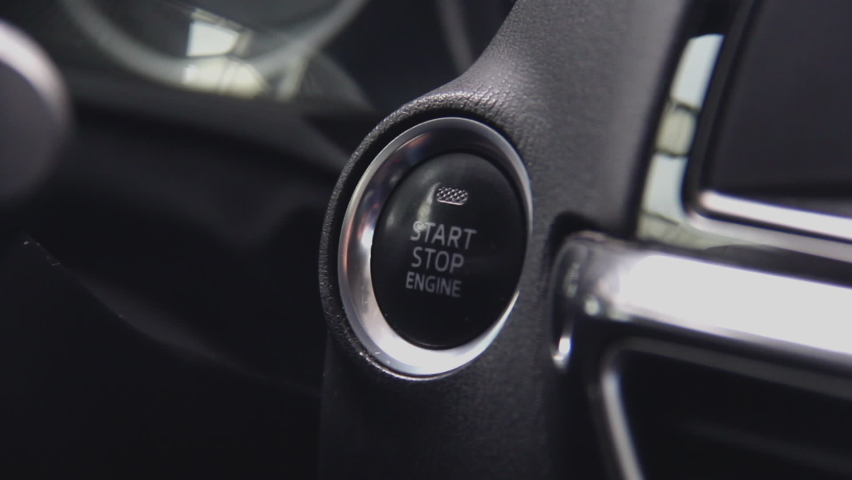 Starting car engine. Track in to the button. Finger press the button to start the car engine | Shutterstock HD Video #1058607064