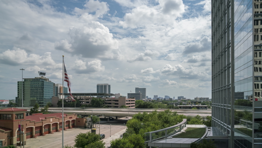 Time Lapse of Downtown Houston With Fire House and Flag in the Foreground