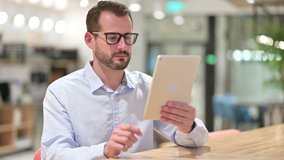 Businessman doing Video Call on Tablet in Office. - Powered by Shutterstock - Get 15% off with code: PIKWIZARD15