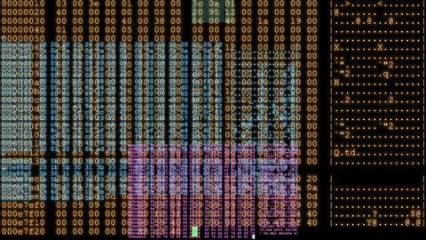 Multicolored lines of computer code repeating across screen in real-time against a black background - seamless looping.