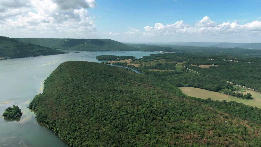 aerial footage of a lake surrounded by trees and mountains