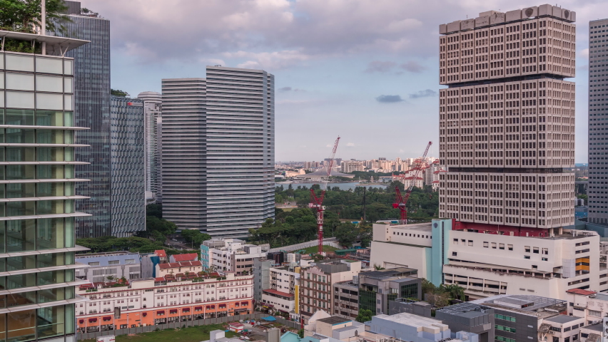Evening aerial view to Tanjong Rhu look out tower in Singapore timelapse. This was once a busy area with shipyards but have now transformed into a beautiful residential area. Skyscrapers around