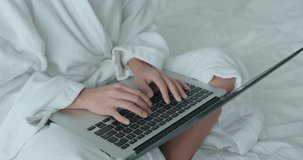 Woman work on laptop computer at hotel room at quarantine period