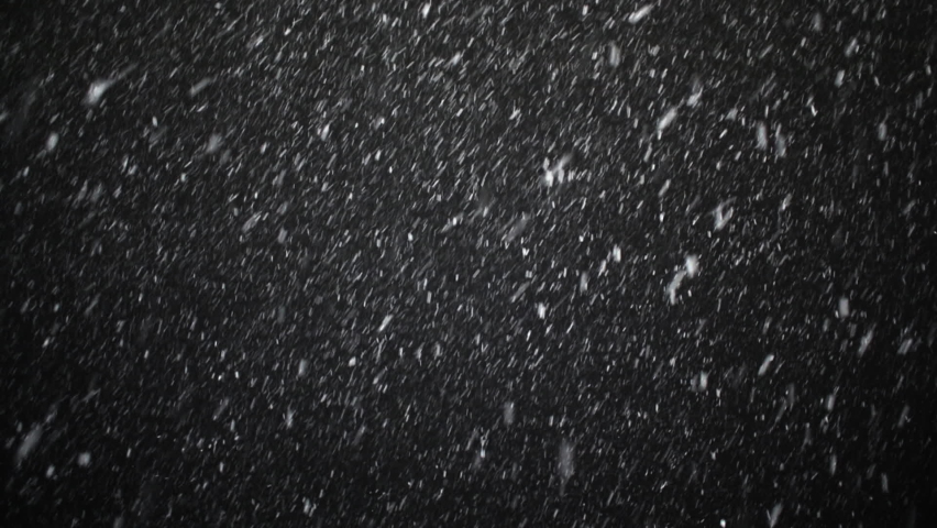 A dense heavy blizzard snowstorm VFX insert in slow-motion on black screen. Black screen Christmas snowstorm. Particles swirling moved by wind. Snow is moving through space. Snowstorm on black. Royalty-Free Stock Footage #1058627680