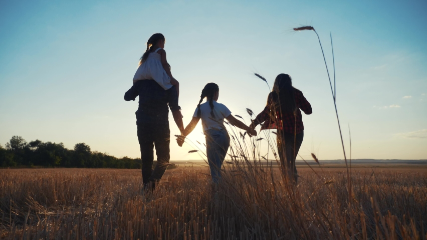 People in the park. happy family silhouette walk at sunset. mom dad and daughters walk holding hands in the park. happy family kid dream concept. parents and fun children walking back silhouette | Shutterstock HD Video #1058628376