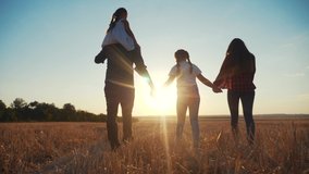 people in the park. happy family silhouette walk at sunset. mom dad and daughters walk holding hands in the park. happy family kid dream concept. parents and fun children walking back silhouette - Powered by Shutterstock - Get 15% off with code: PIKWIZARD15