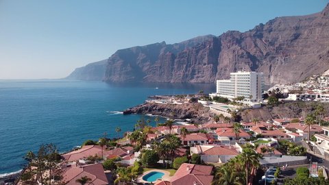 Aerial view of Puerto de Santiago village with Cliffs of the Giants in the background Tenerife, Canary islands, Spain. High quality 4k footage