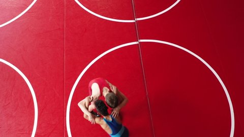 Unique overhead view of youth wrestlers in a live wrestling drill