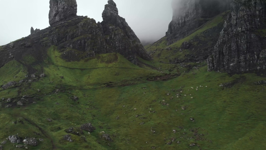 Aerial drone view of old man of storr in isle of Skye scotland, green landscape during a cloudy day