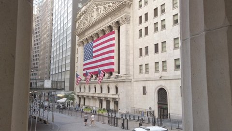 New York / USA - Sep 5, 2020: New York Stock Exchange (NYSE) building exterior. Filmed during Coronavirus pandemic. US flags on building. Empty streets. 