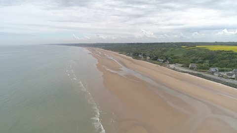 Establishing aerial drone view of isolated Omaha Beach near Colleville sur Mer, Normandy, France