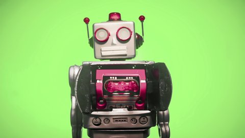 a retro robot with a spinning head left then right loop on a green screen