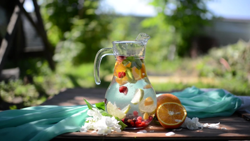 Fresh lemonade with fruit in nature | Shutterstock HD Video #1058648833