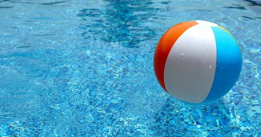 Beach ball in pool. Colorful inflatable ball floating in swimming pool, summer vacation concept. | Shutterstock HD Video #1058653600