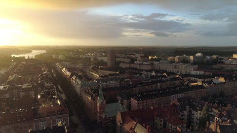 Stockholm city rainy sunset aerial view. Drone shot flying over apartment buildings in central Stockholm at dusk