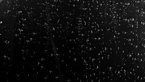 Water Drops following down on black background. Drops of Rain trickling down isolated. Perfect for digital composing. Best 4K High Quality footage Droplets of Water on Black Glass running down.  - Powered by Shutterstock - Get 15% off with code: PIKWIZARD15