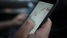 Hands with a mobile phone, checking stock market data. Scrolling through, touching stock market graph on a touch screen device close up - Powered by Shutterstock - Get 15% off with code: PIKWIZARD15