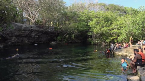 Cristalino Cenote  / Mexico - MARCH 24, 2019:
Tourist activities with pool jumping in the Cristalino Cenote.