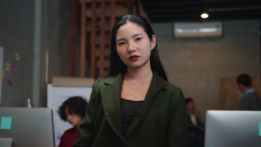 Unhappy Asian Businesswoman looking at camera and Doing Crossing Hand Sign or x sign in a creative office workplace. Female Worker Saying no, Rejection, and Stop Sign by using hand gesture. Royalty-Free Stock Footage #1058665567