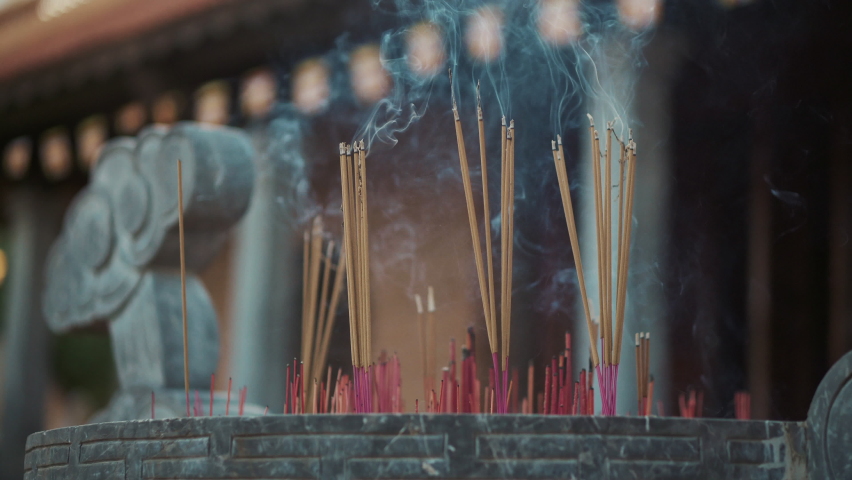 Incense sticks is burning in asian buddhist temple, details of ritual and tradition | Shutterstock HD Video #1058666365