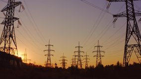 Silhouette of high-voltage towers. Electricity pylons on energy station on the background of beautiful sky at sunset. Electricity station and high-voltage power lines.View from below. - Powered by Shutterstock - Get 15% off with code: PIKWIZARD15