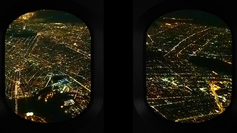 The view from the windows of a private jet as it approaches a landing over New York city at night.