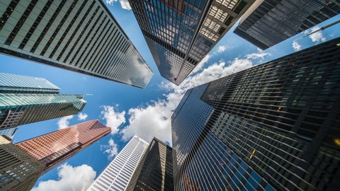 Business and finance concept time lapse, looking up at office building architecture in the financial district, Toronto, Ontario, Canada.