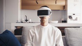 Slow motion scene video of young caucasian man using VR device fun virtual computer or video games feel excited - Powered by Shutterstock - Get 15% off with code: PIKWIZARD15