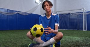 Portrait of asian professional football player, korean man after soccer training, serious athlete, indoor stadium field, professional arena, motivational video. Creative Teenagers hobbies.