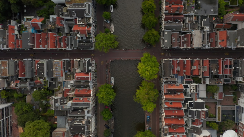 Amsterdam, Netherlands Canal Overhead Birds View with Boat traffic and Red House Rooftops