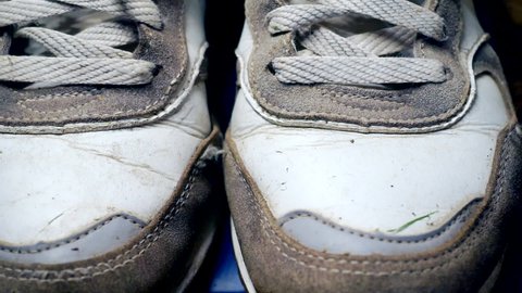 modern casual shoes.sports background.old worn leather sport training sneakers close-up.