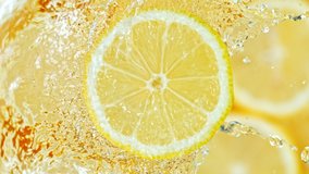 Super Slow Motion Shot of Splashing Water on Rotating Lemon Slice at 1000fps. - Powered by Shutterstock - Get 15% off with code: PIKWIZARD15