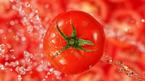 Super Slow Motion Shot of Splashing Water on Rotating Tomato at 1000fps.