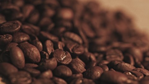 Fragrant coffee beans are roasted in a frying pan, smoke comes from coffee beans.