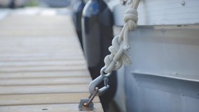 Floating Boat Rope Attached To The Steel Hook Rigid On A Wooden Dock. - Close up