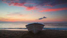 Tropical Seascape with a boat on sandy beach at cloudy sunrise or sunset