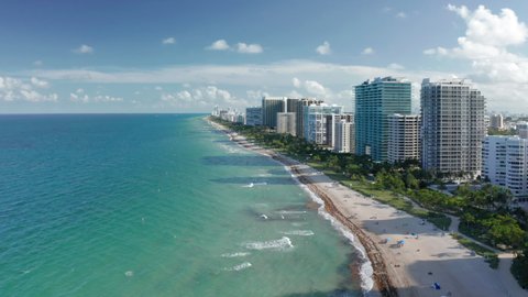 Best background for travel business. Aerial view of clean light-green sea waters. Residential front line buildings with beautiful Atlantic ocean view. South Beach nature at sunset, Florida, Time Lapse