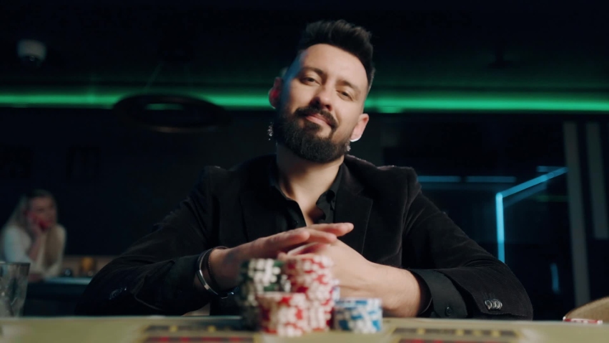 Bearded man is playing poker in casino. Man is winning and throwing four aces. Royalty-Free Stock Footage #1058707912
